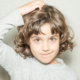 Girl itching her head because she has lice