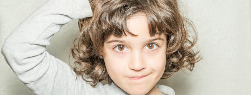 Girl itching her head because she has lice