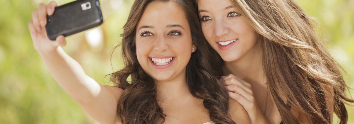 Two girls taking a selfie and smiling