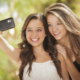 Two girls taking a selfie and smiling