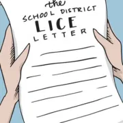 Young parent holding a school lice letter in Spring Grove Illinois